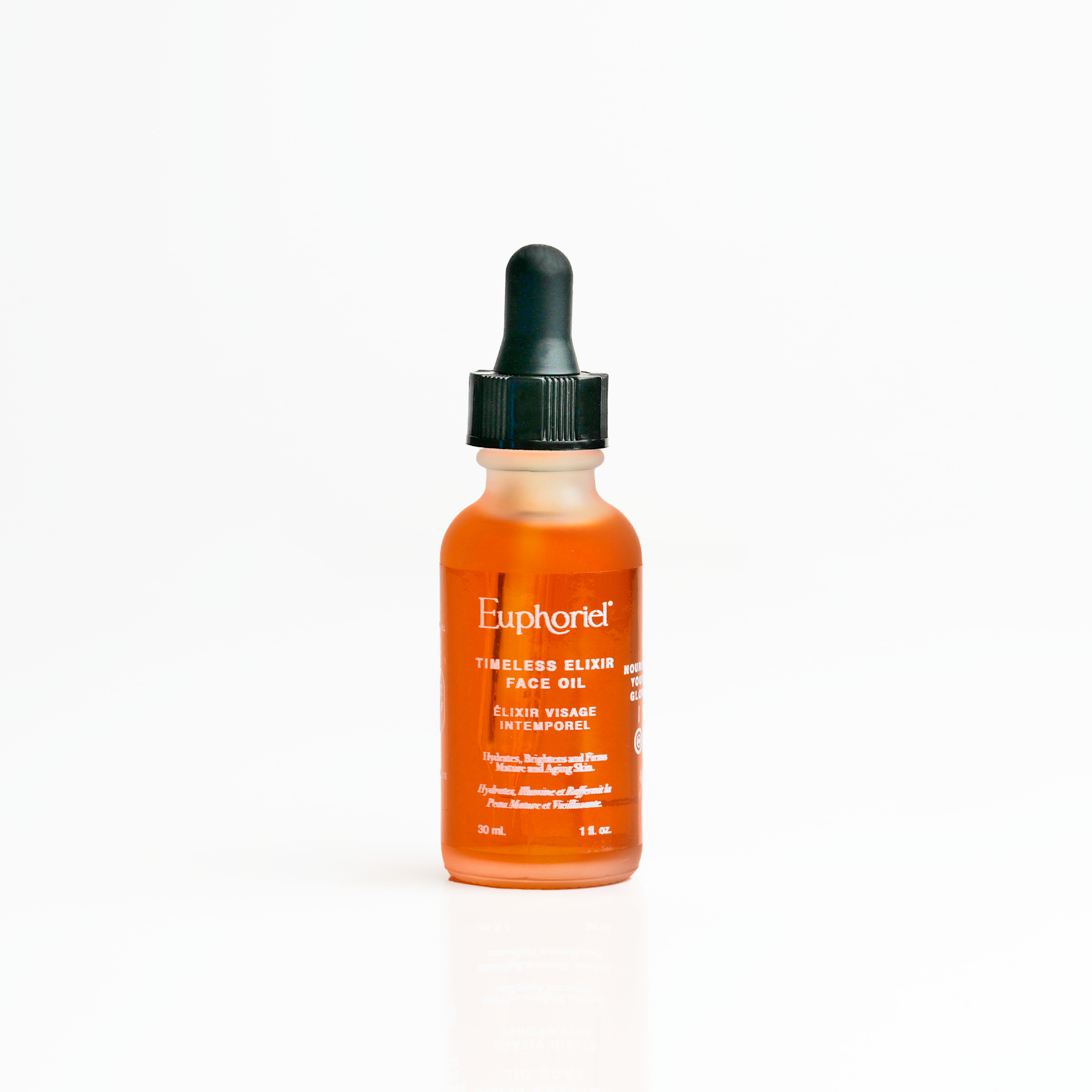 A small dropper bottle of Euphorie Timeless Elixir Face Oil with orange liquid visible inside the bottle.