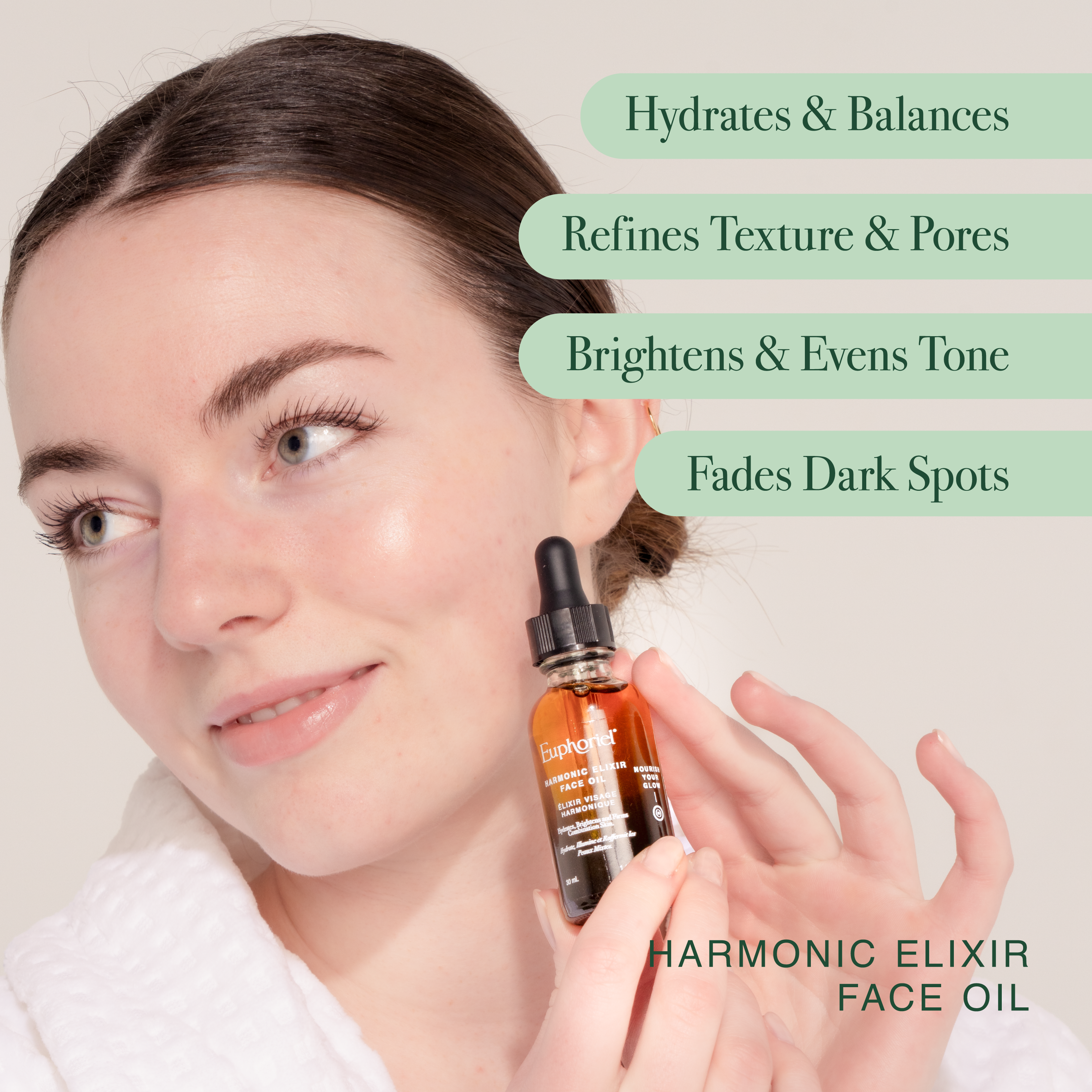 Woman holding a bottle of 'Harmonic Elixir Face Oil' with text highlighting its benefits.