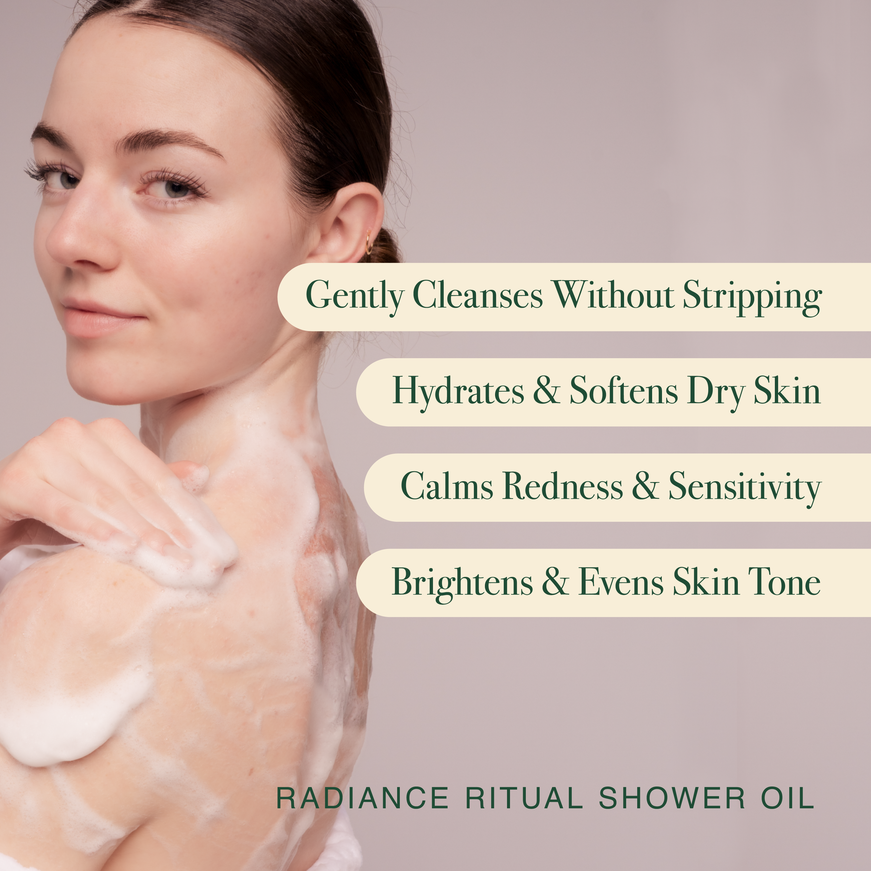 Woman with shower oil on her skin against a neutral background