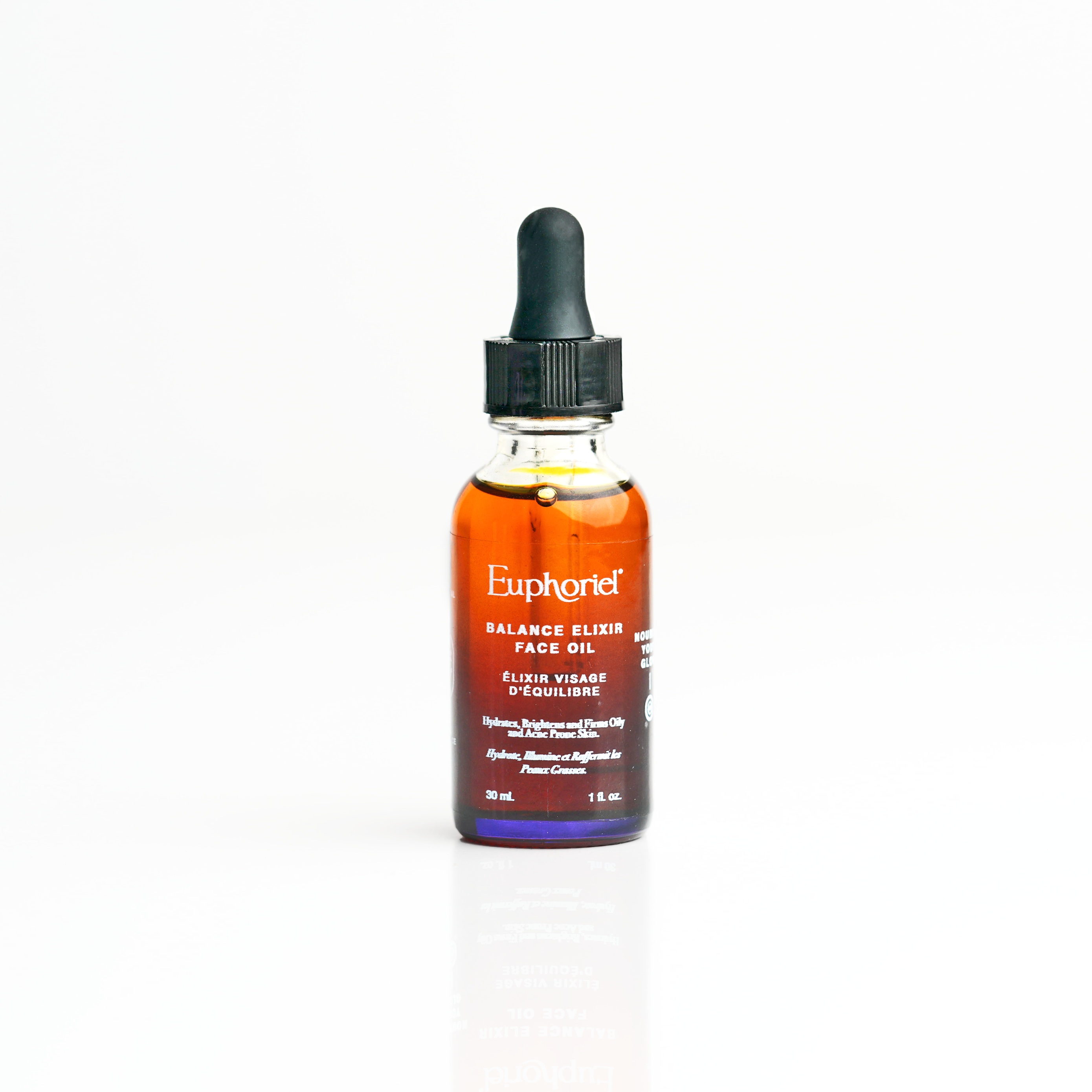 A bottle of Balance Elixir Face Oil with a dropper, labeled for pores refining and purifying purposes.